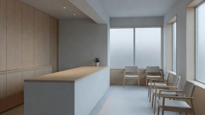 Quiet modern dental clinic waiting area in Japan with natural light and simple seating
